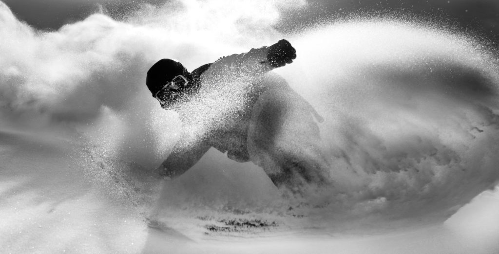 photo - snowboarder turning in powder by David Gillette