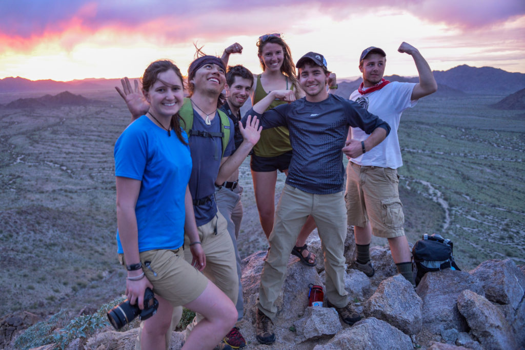 photo - group of Outdoor Education students celebrating on a summit