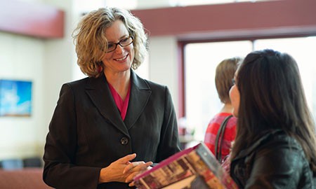photo - CMC President Carrie Hauser talks to a CMC student.