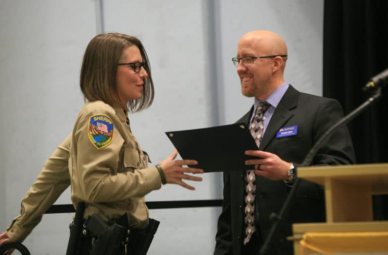 Photo: Standout graduate Samantha Alexandra of the Garfield County Sheriff’s Office receives her graduation certificate from Stewart Curry, program director, at CLETA’s commencement on Dec. 14. Photo David Watson