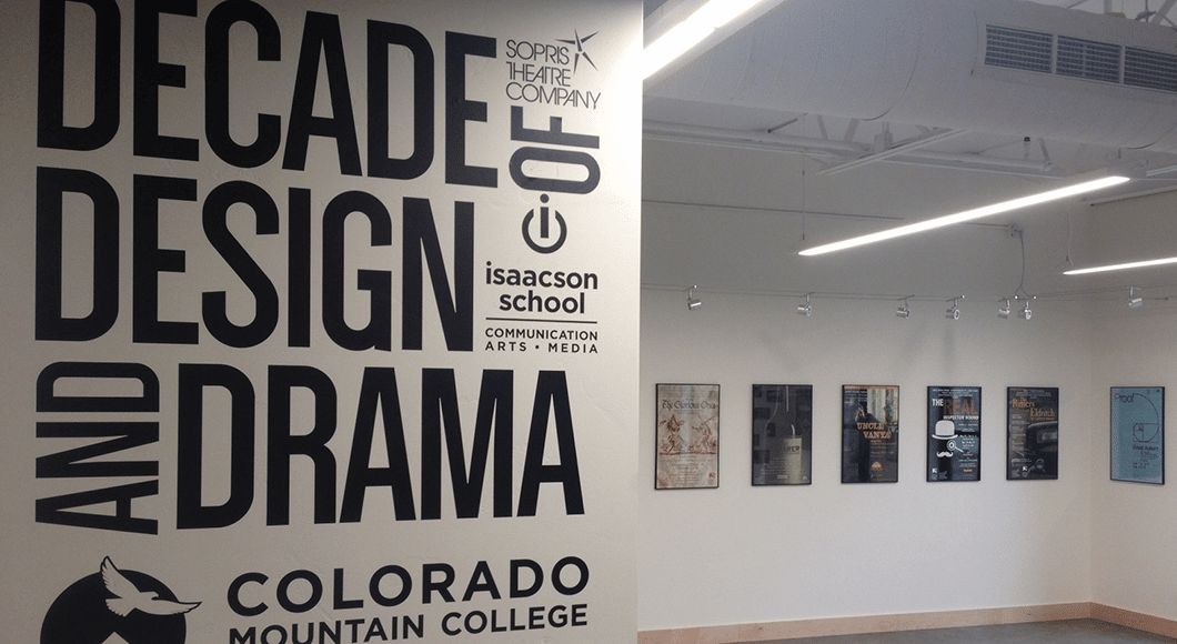 Photo: ArtShare Gallery at Morgridge Commons. Sign reads "Sopris Theatre Company: Decade of Design and Drama / Colorado Mountain College