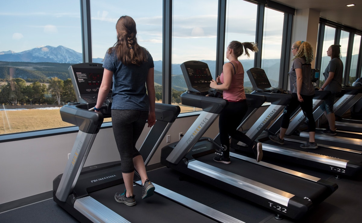 With an expansive view of Mt Sopris, students and community members work out on treadmills in the CMC Spring Valley Outdoor Leadership Center & Field House.