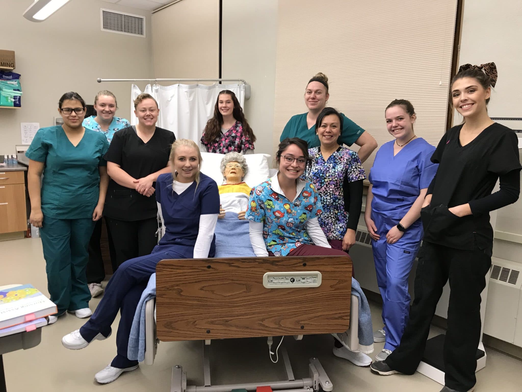 CMC Certified Nurse Aides pose with a simulated patient