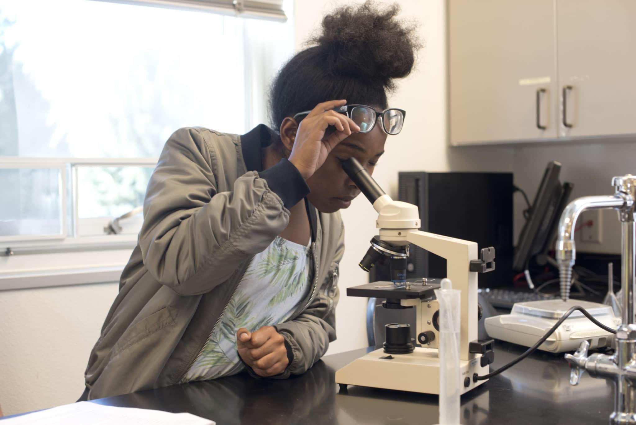 CMC Spring Valley student at her microscope.