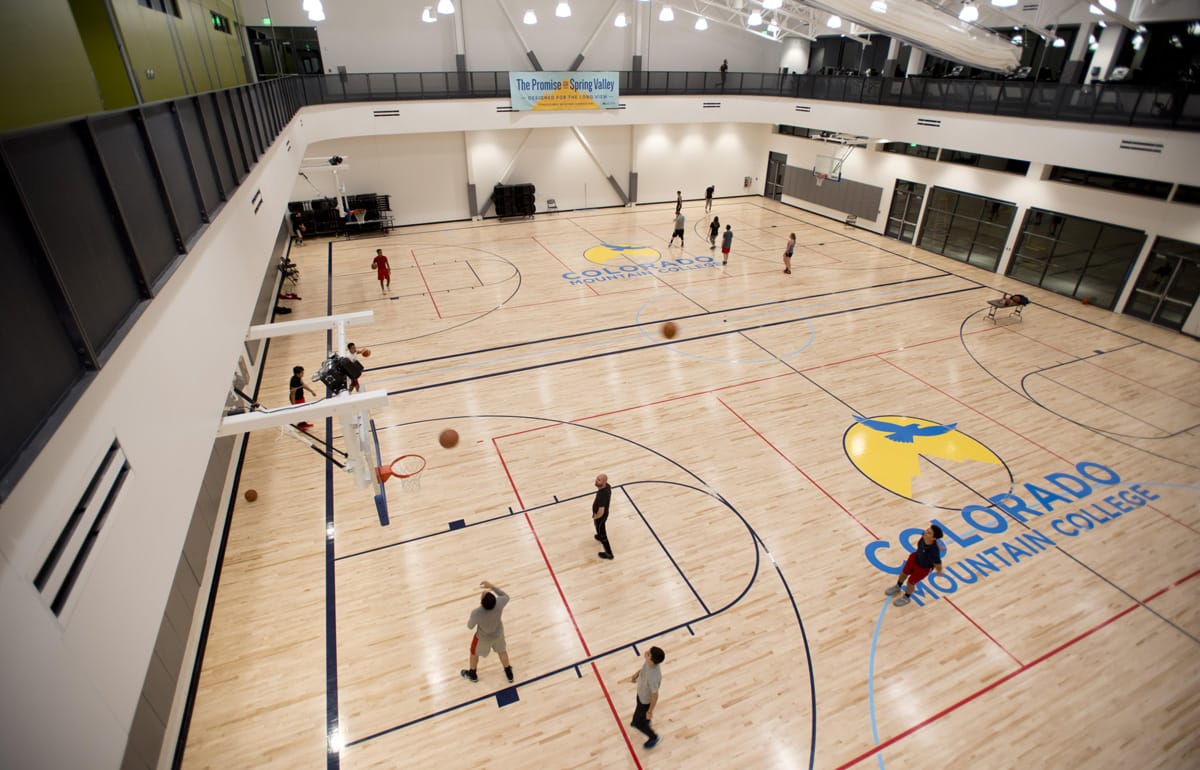 Side-by-side, full-size basketball courts in use at the CMC Spring Valley Field House.