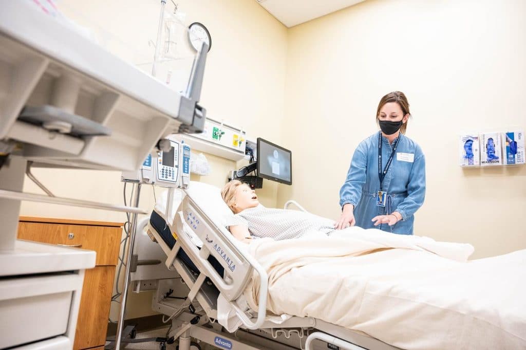 Assistant Professor Courtney Smazinski works with a training manikin at the CMC Steamboat Spring nursing simulation lab. Photo by Benjamin Suddendorf