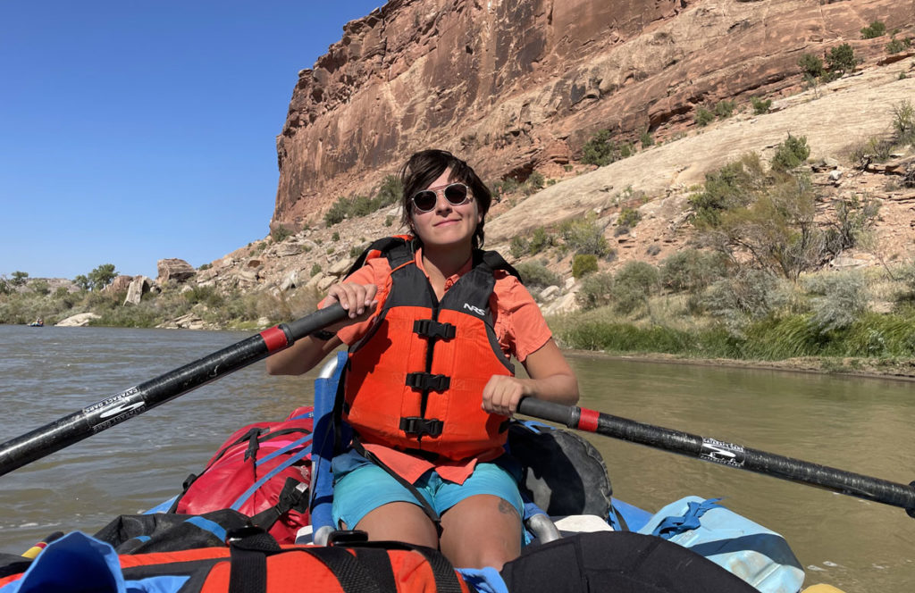 CMC Outdoor Education Program student guides a raft on the Colorado River.