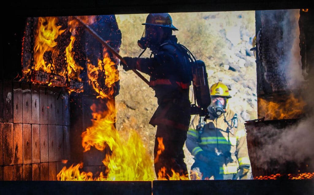 CMC Firefighting students drill in a live burn exercise.