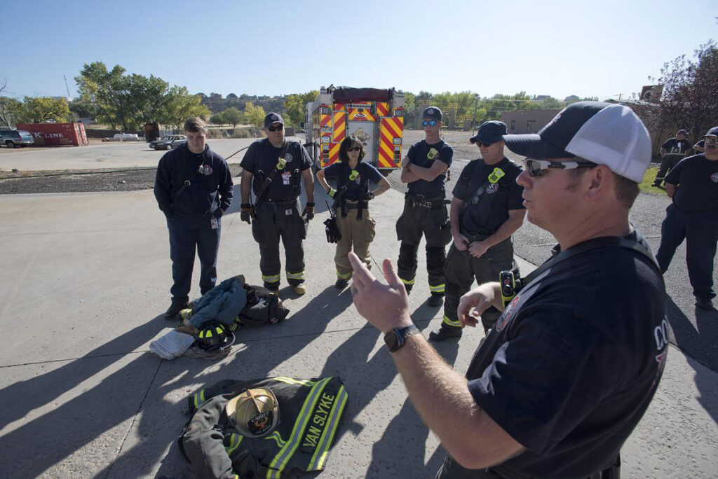 CMC Firefighting instructor and students debrief after training.