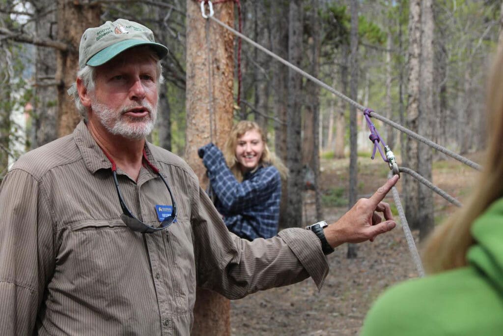CMC Outdoor Recreation Leadership instructor demonstrates rope rigging.