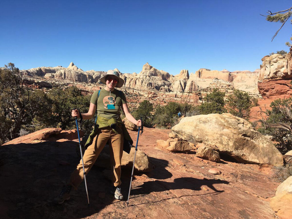 CMC Outdoor Education student poses on a slickrock overlook during a desert orientation trip.
