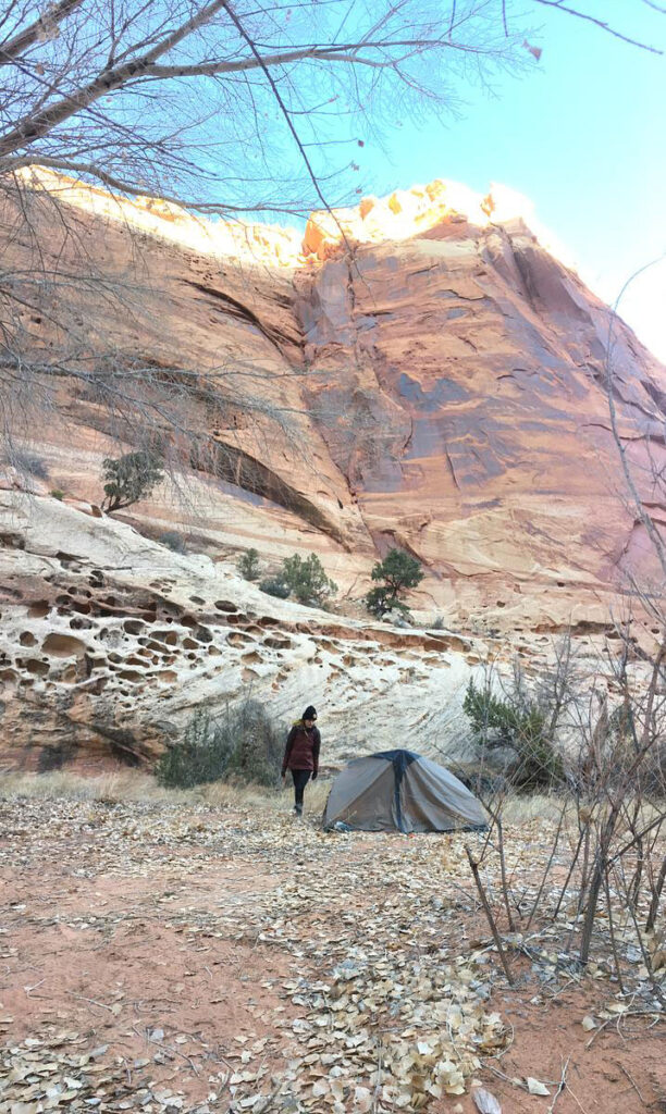 CMC Outdoor Education student and her tent setup in a canyon during a desert orientation trip.