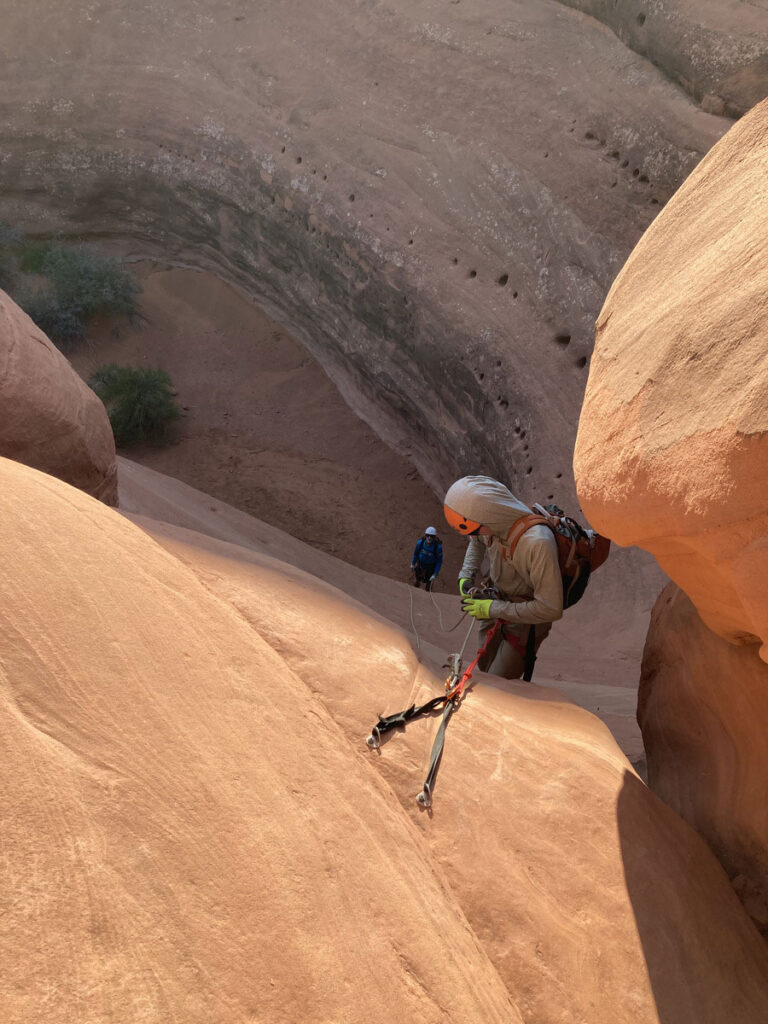 CMC Outdoor Education student rappelling into a desert canyon..