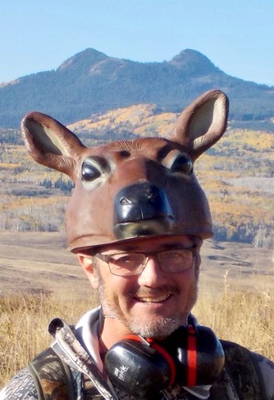he author/guide with his cow elk head hat, pre-bear encounter in front of Bears Ears peak.