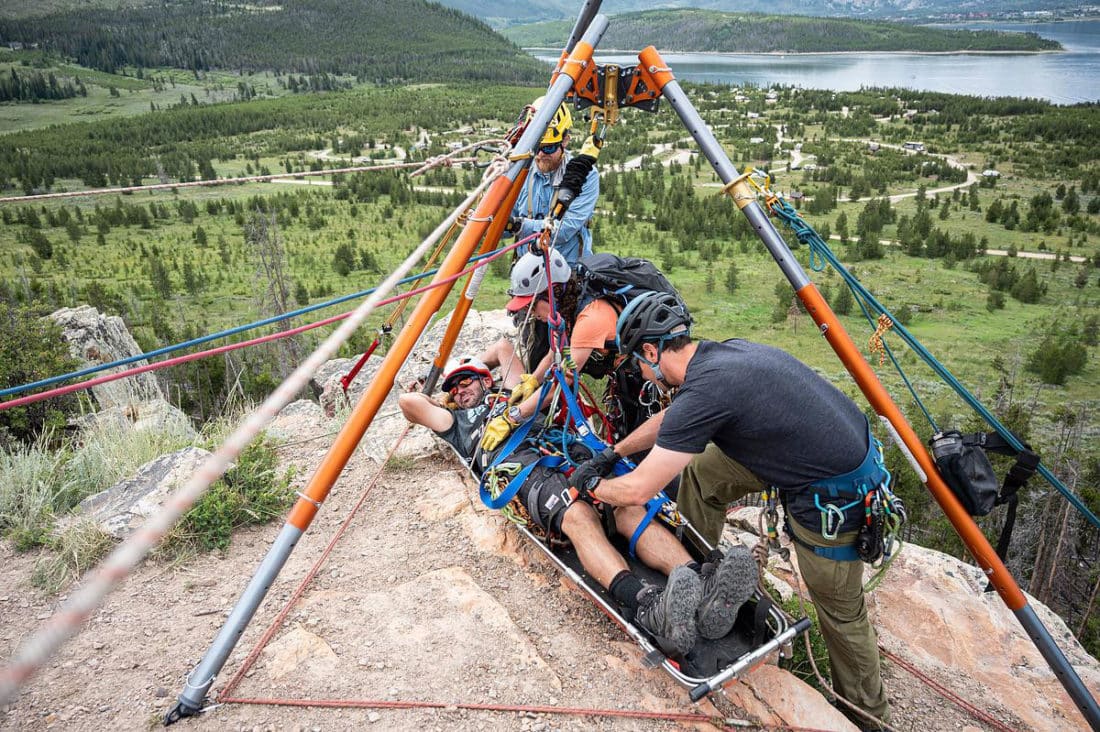 A CMC Rope Rescue Technician class sets up a high angle rescue in the field.